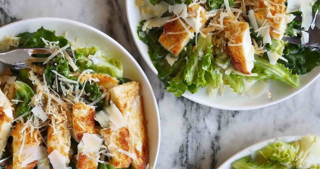 Easy Caesar Chicken Recipe: Creamy, Flavorful, and Quick 15 "Whisking Caesar dressing ingredients, including mayonnaise, Parmesan, garlic, and lemon juice, in a bowl.